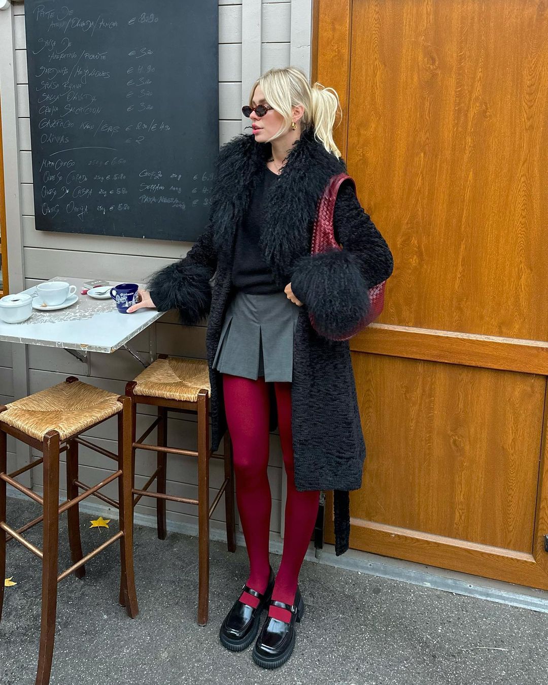 https://media.thecoolhour.com/wp-content/uploads/2023/11/22103952/add-color-into-your-winter-outfit-with-red-tights.jpg