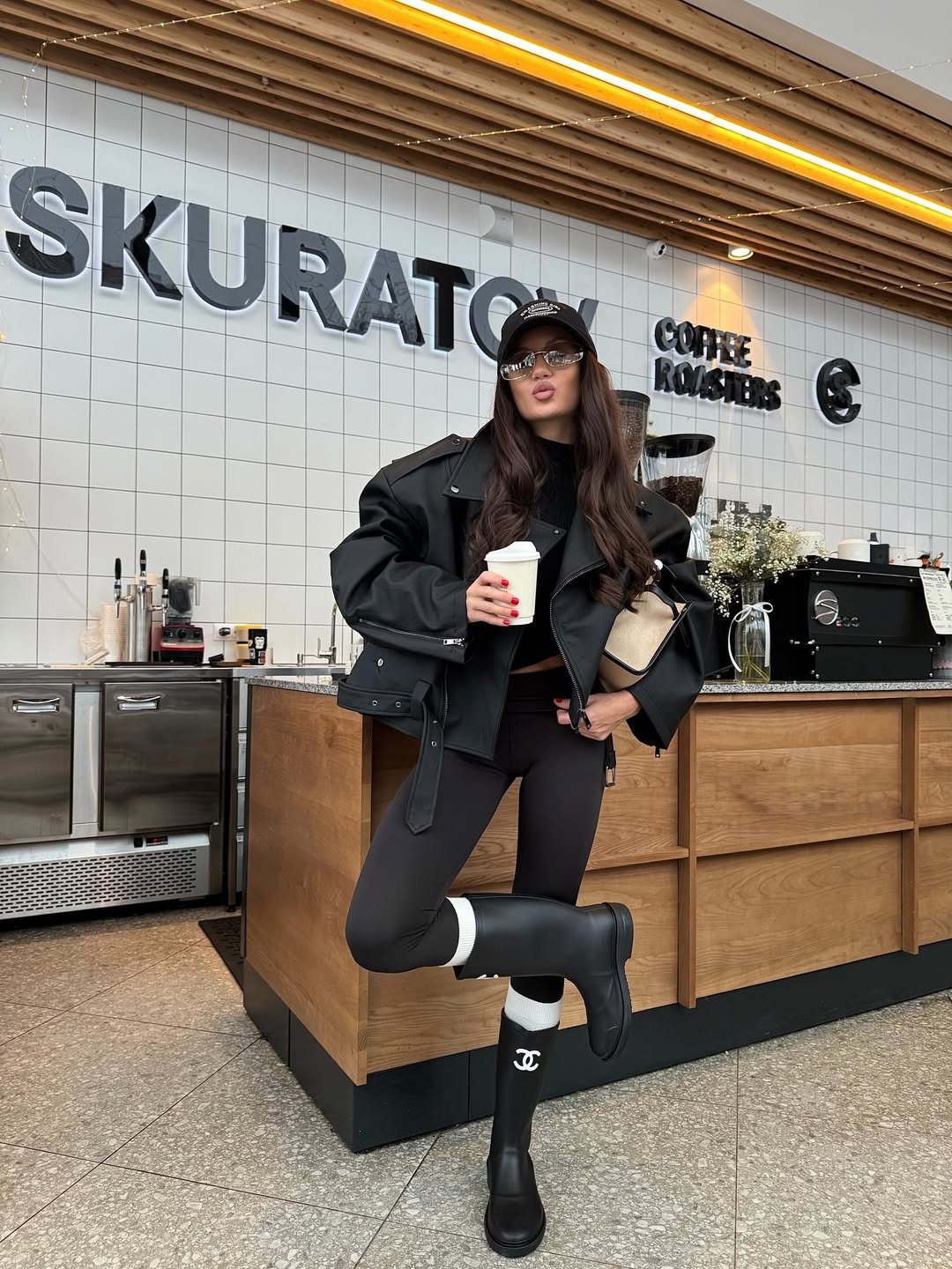 fashion blogger wearing black leggings and rain boots