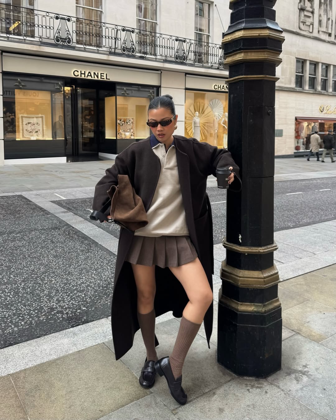 Fashion Blogger Wearing Knee High Socks And A Pleated Skirt