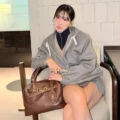Momo Heads to Miu Miu’s Spring 2027 Show in a Gray Mini and Hoodie